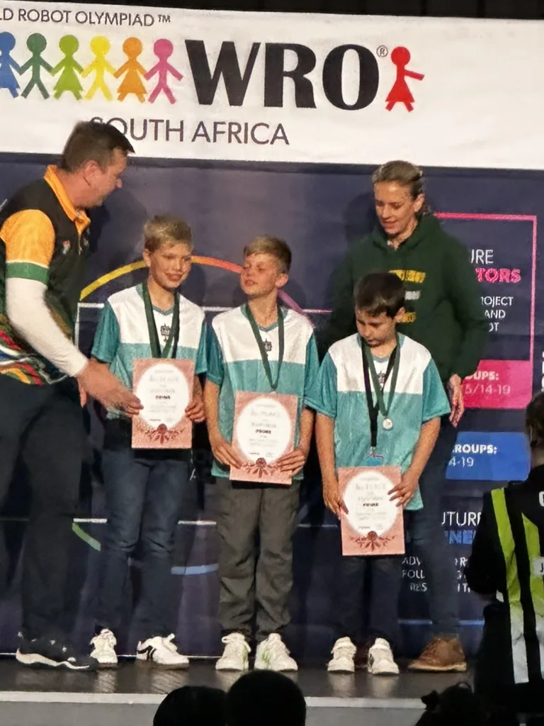 Robotics League team receiving medals on the WRO South Africa podium