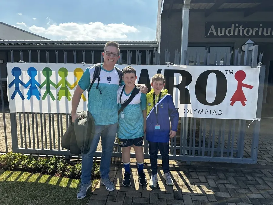 Coach and two students at the WRO South Africa venue gate